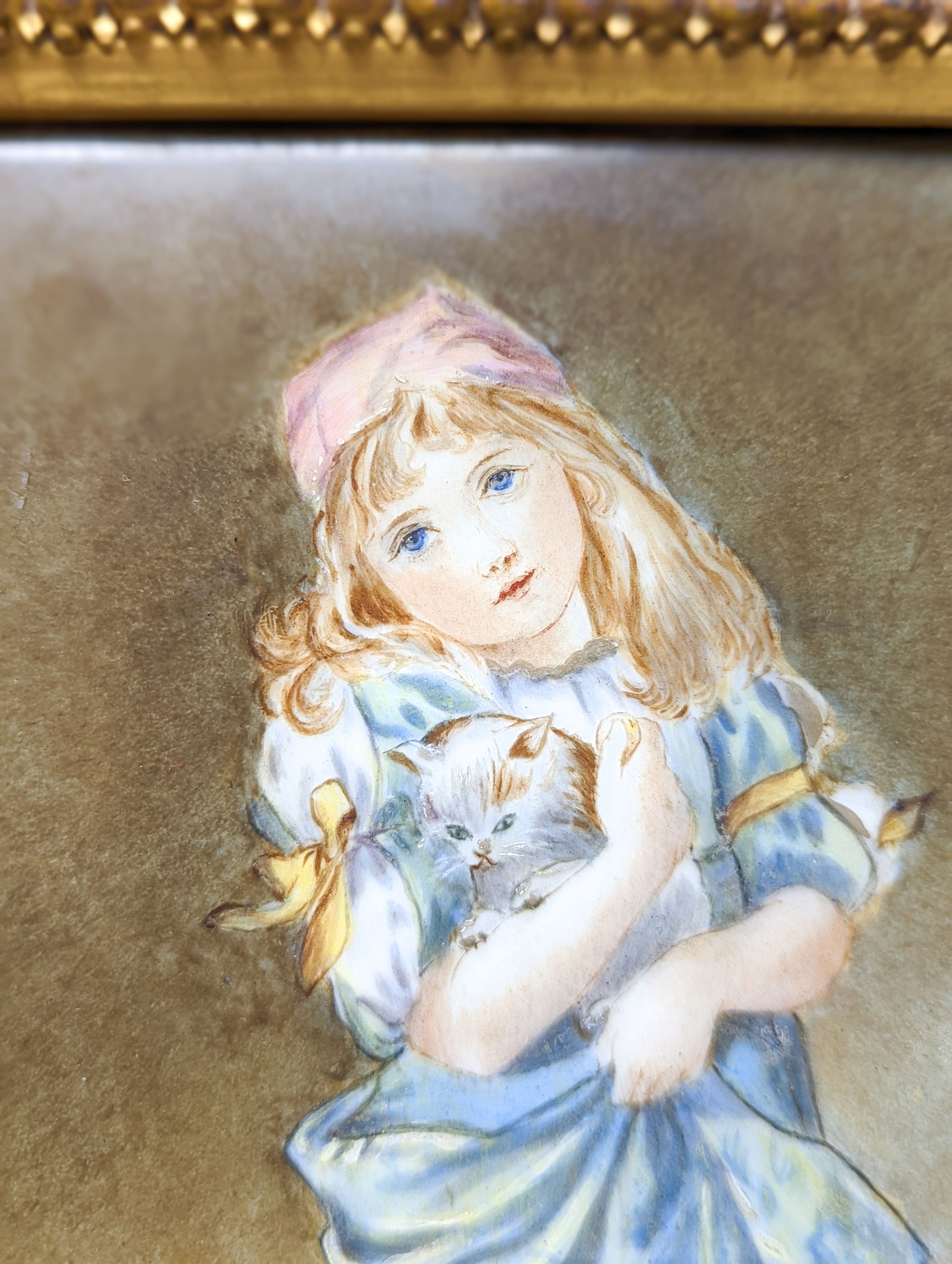 A Victorian porcelain plaque, painted with a girl with kittens, in gilt frame, 28.5 X 21 cm